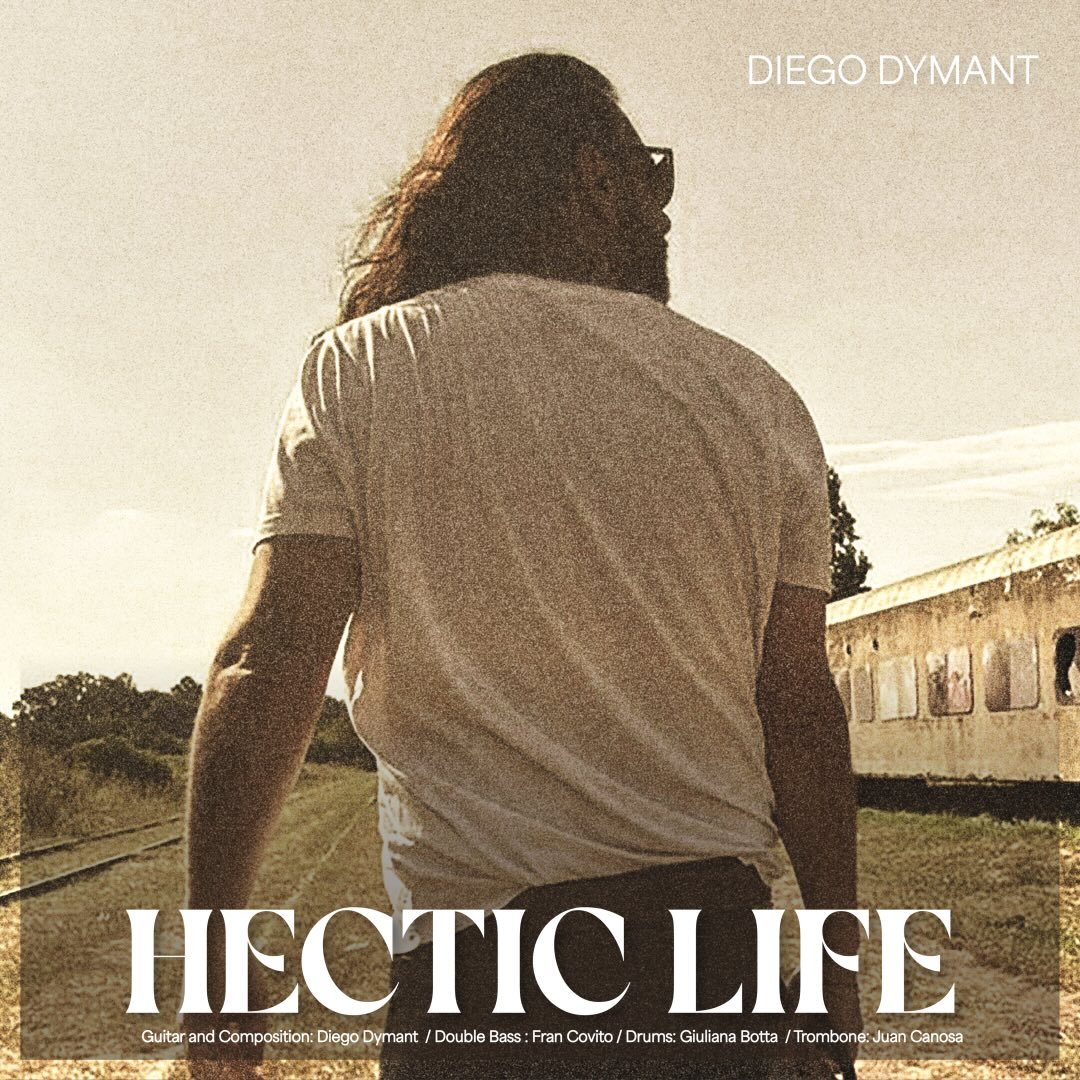 Diego Dymant de espaldas caminando junto a vías de tren abandonadas, portada del single Hectic Life